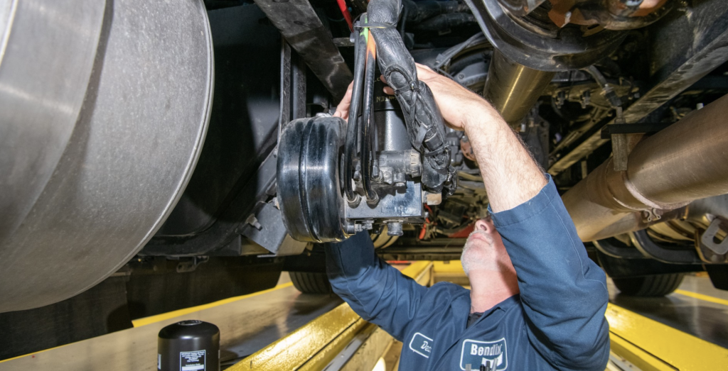 Professional technician working on truck brakes