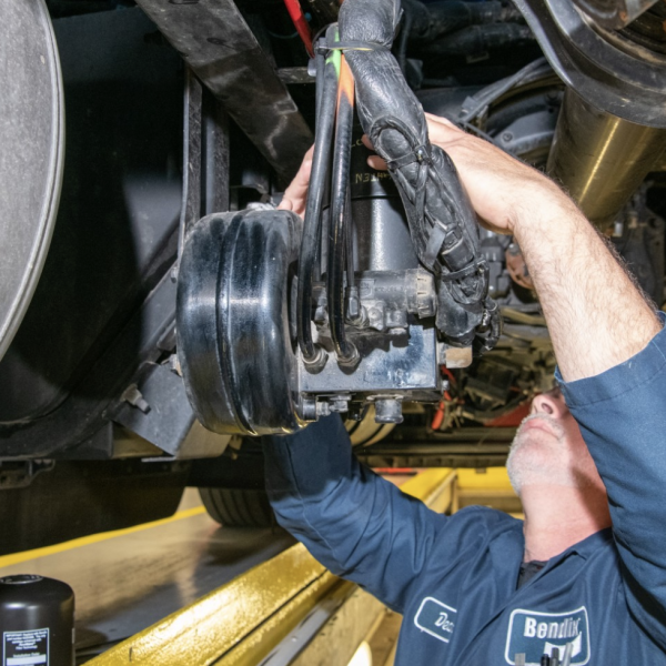 Professional technician working on truck brakes