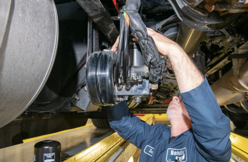 Professional technician working on truck brakes